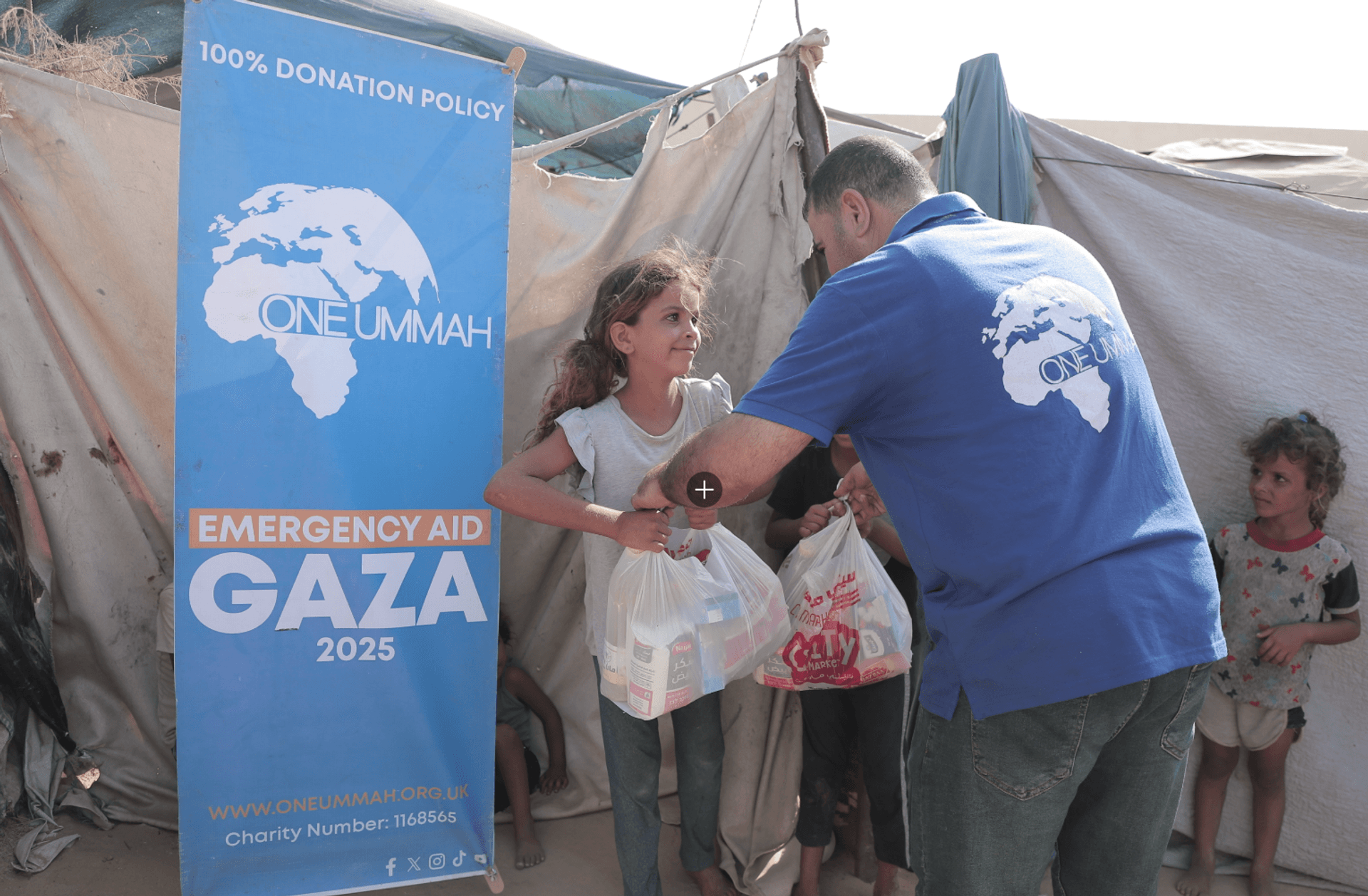 Gaza emergency aid pack on an older man’s back with destruction in the background.
